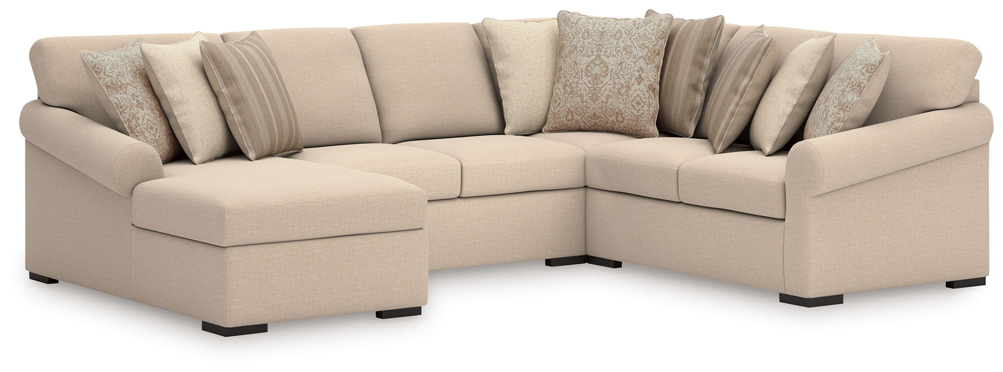 Light beige sectional sofa with corner chaise and layered striped and floral pillows