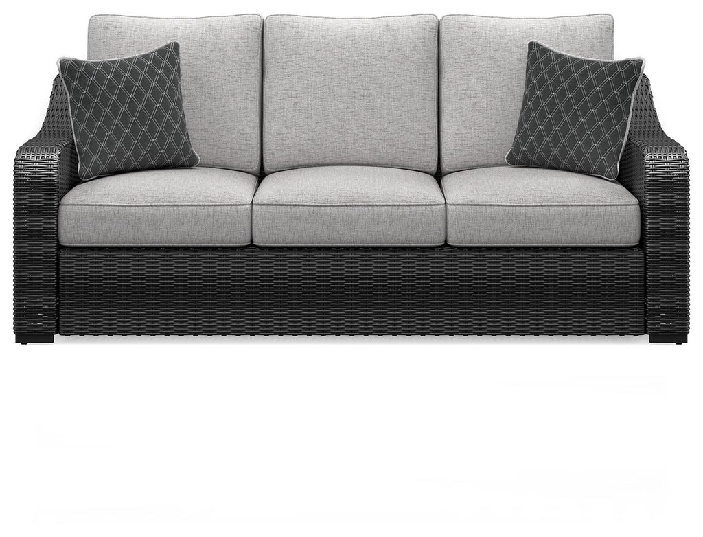 Beachcroft sofa with cushions, dark wicker base, light gray seat and back with two pillows