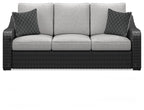 Beachcroft sofa with cushions, dark wicker base, light gray seat and back with two pillows