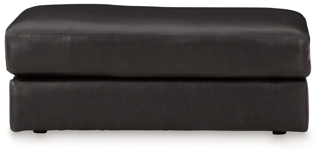 Onyx leather ottoman with wide top cushion and stitched seams, short legs