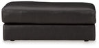Onyx leather ottoman with wide top cushion and stitched seams, short legs