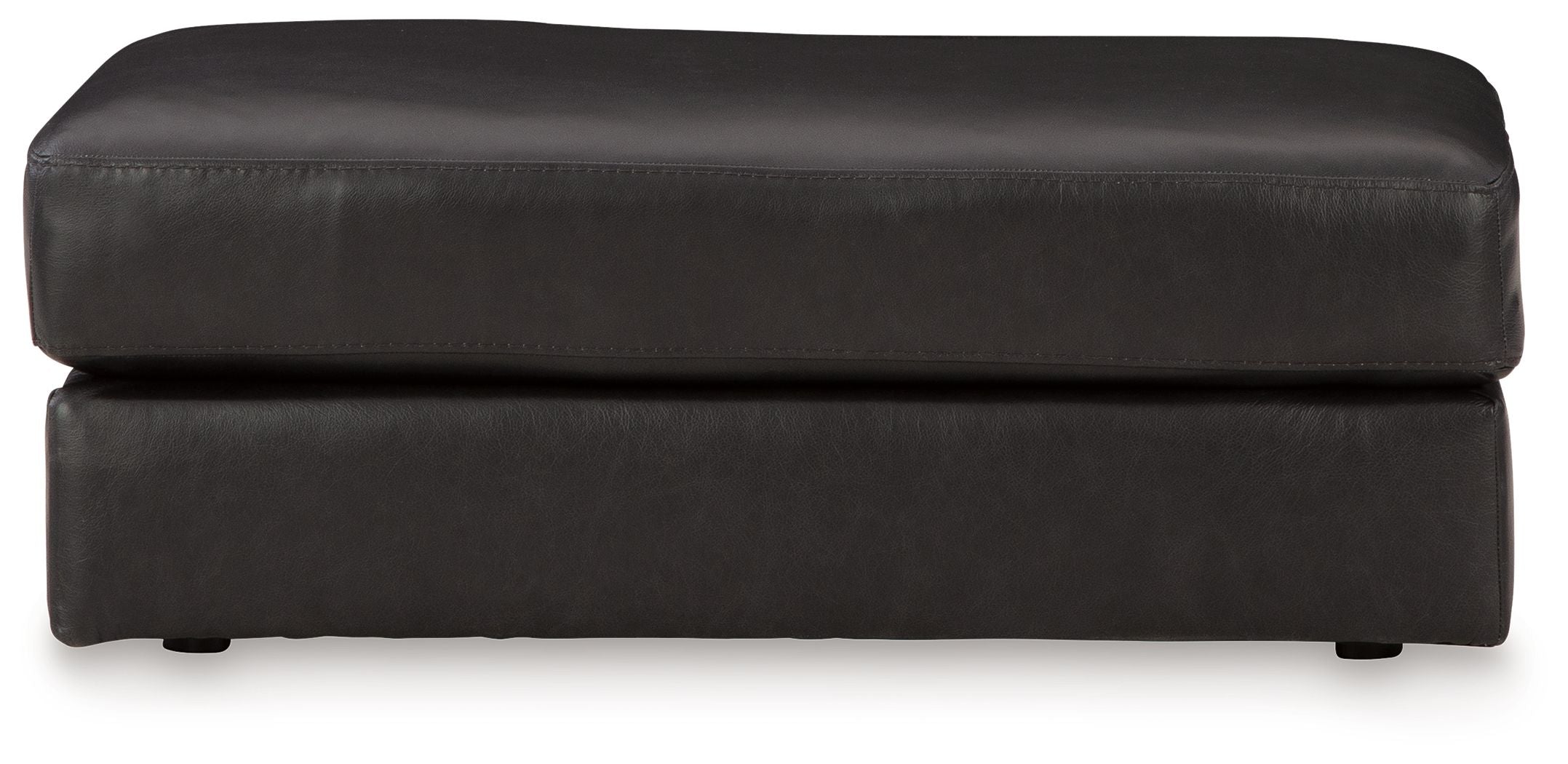 Onyx leather ottoman with wide top cushion and stitched seams, short legs