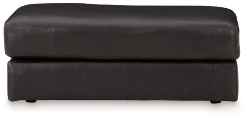 Onyx leather ottoman with wide top cushion and stitched seams, short legs