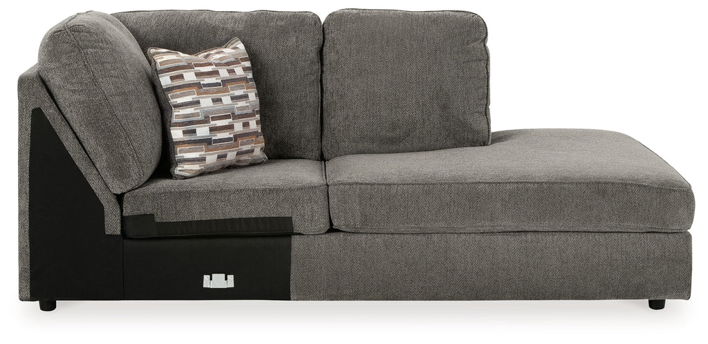 Gray corner chaise with patterned throw pillow and two back cushions