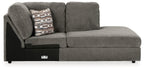 Gray corner chaise with patterned throw pillow and two back cushions