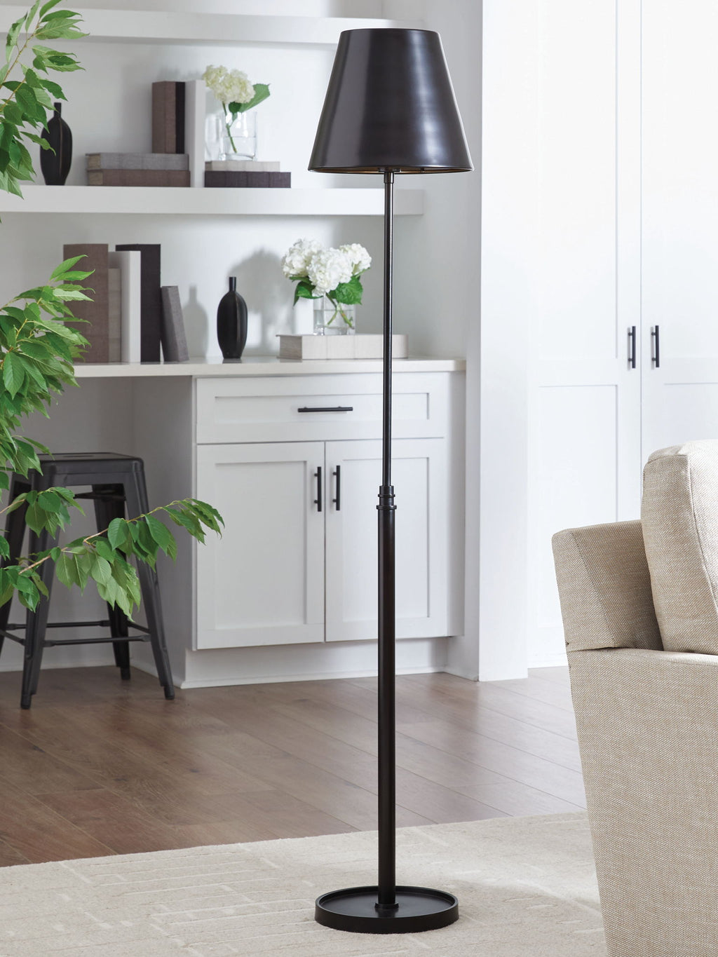 Black metal floor lamp with drum shade and tall slim pole