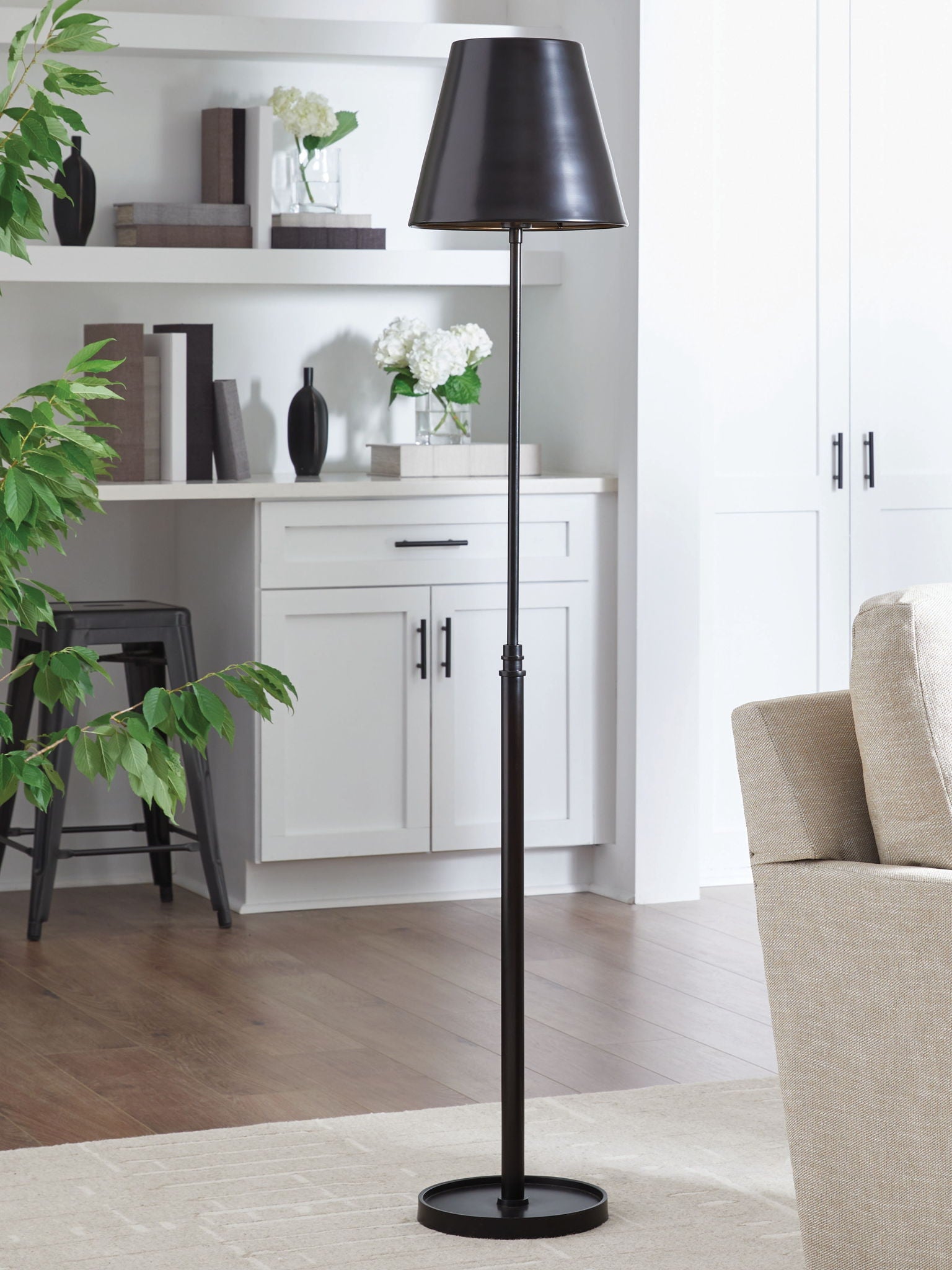 Black metal floor lamp with drum shade and tall slim pole