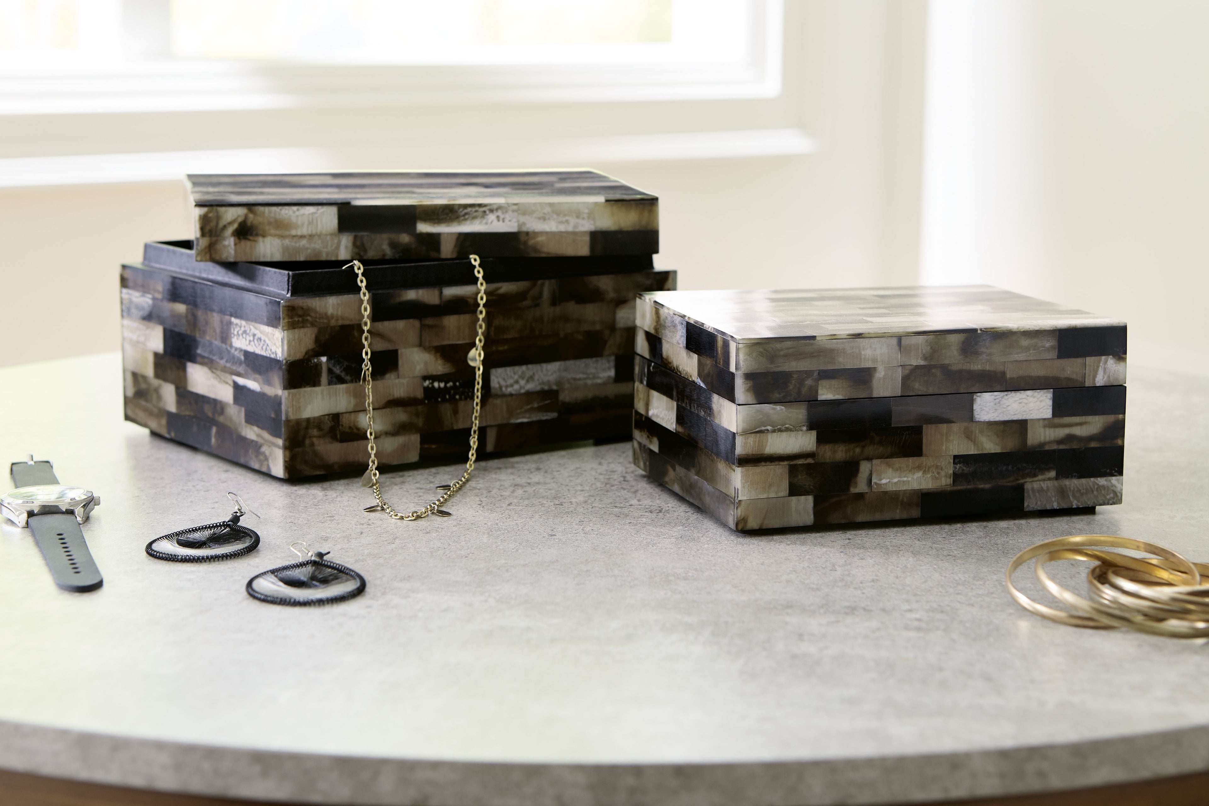 Set of 2 wood block storage boxes with striped black, brown, and cream panels and lids