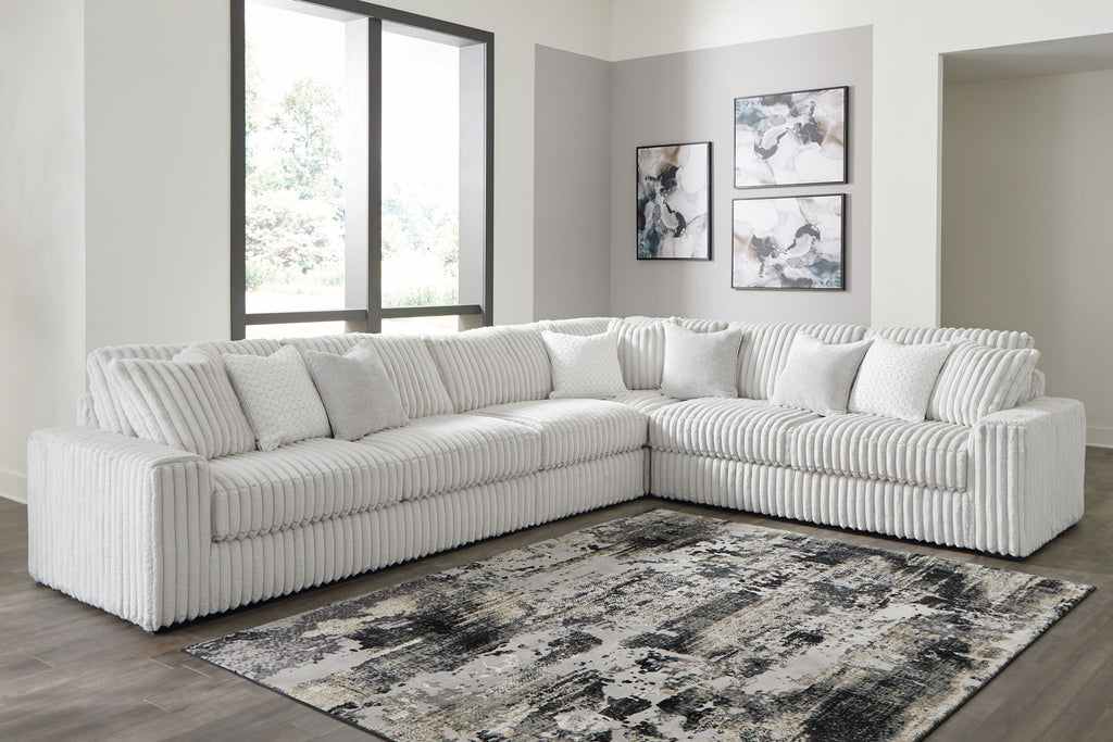 Gray sectional sofa with chaise, ribbed upholstery and plush tufted back pillows