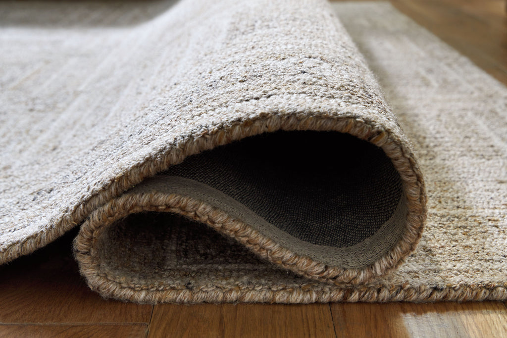 Gray area rug with bound edge and short textured pile