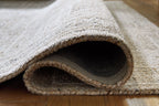 Gray area rug with bound edge and short textured pile