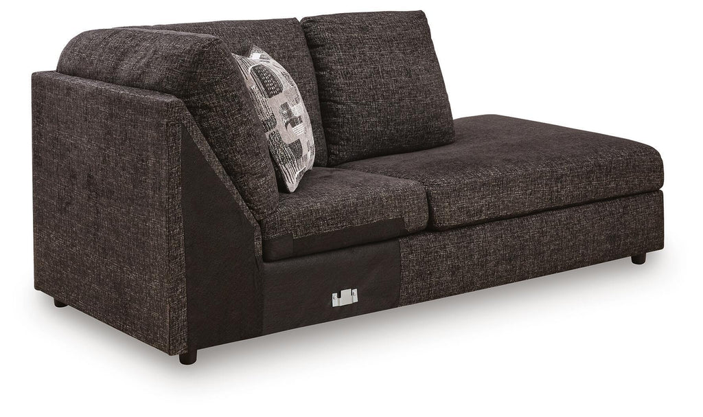 Corner chaise sofa, dark textured fabric, curved arms, patterned back cushion, block legs