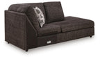Corner chaise sofa, dark textured fabric, curved arms, patterned back cushion, block legs