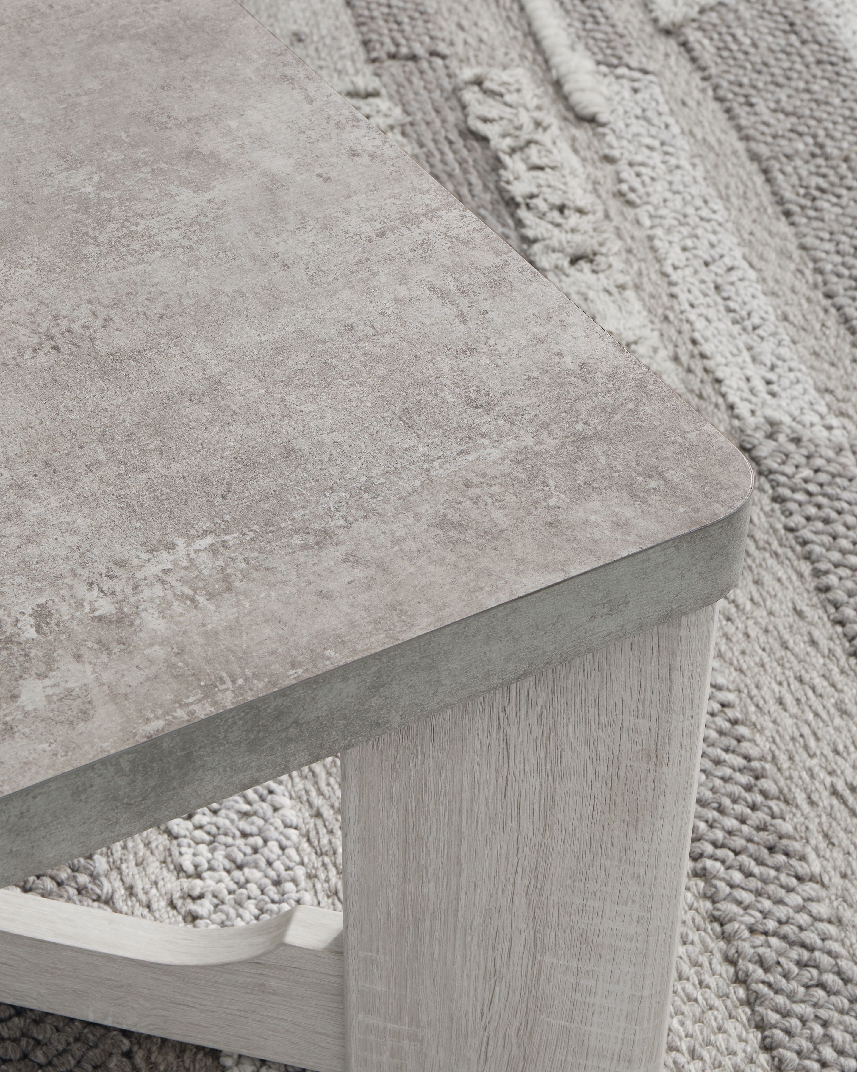 Occasional table with textured gray top and whitewash open side supports