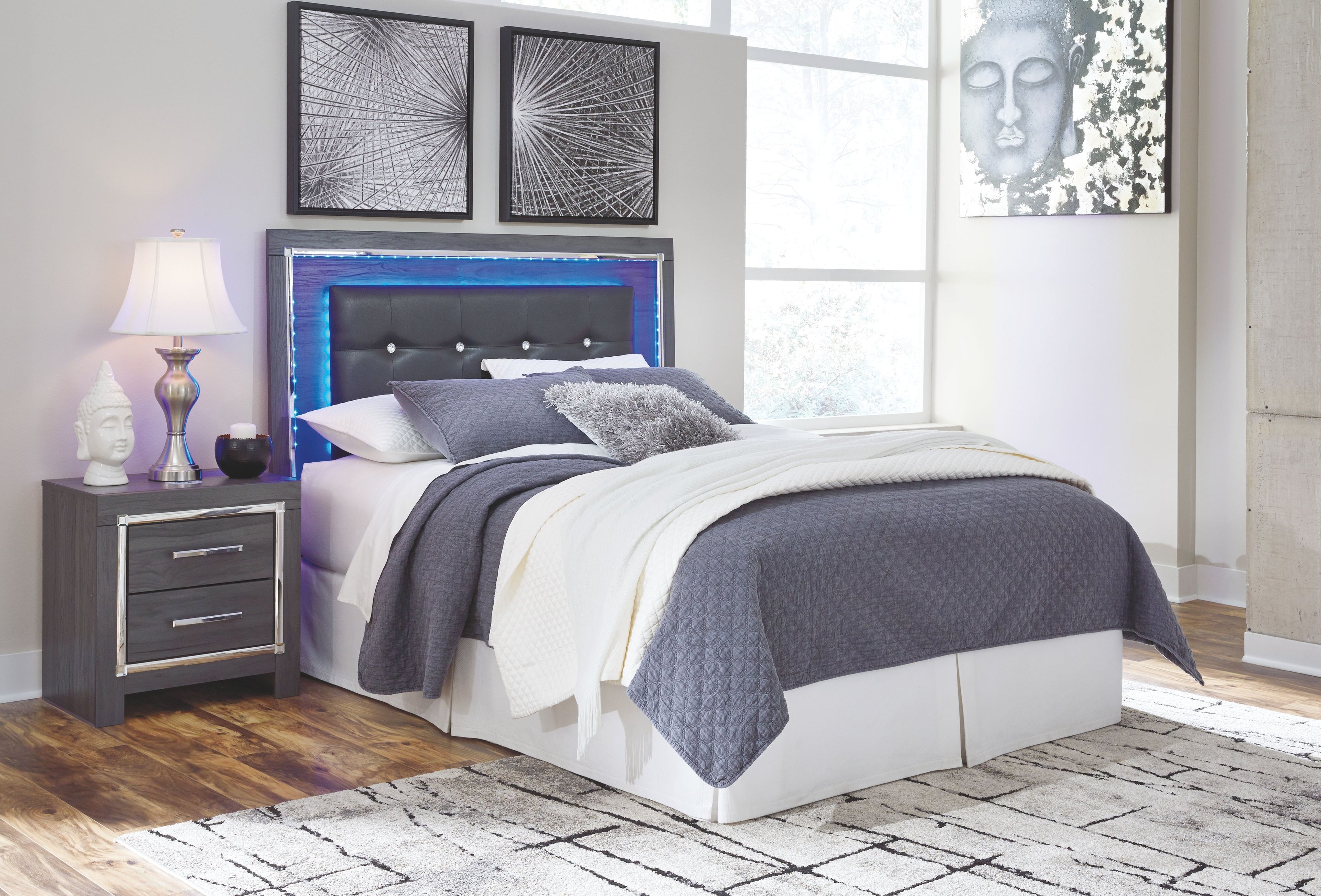 Gray upholstered panel headboard with button-tufted details and blue LED trim