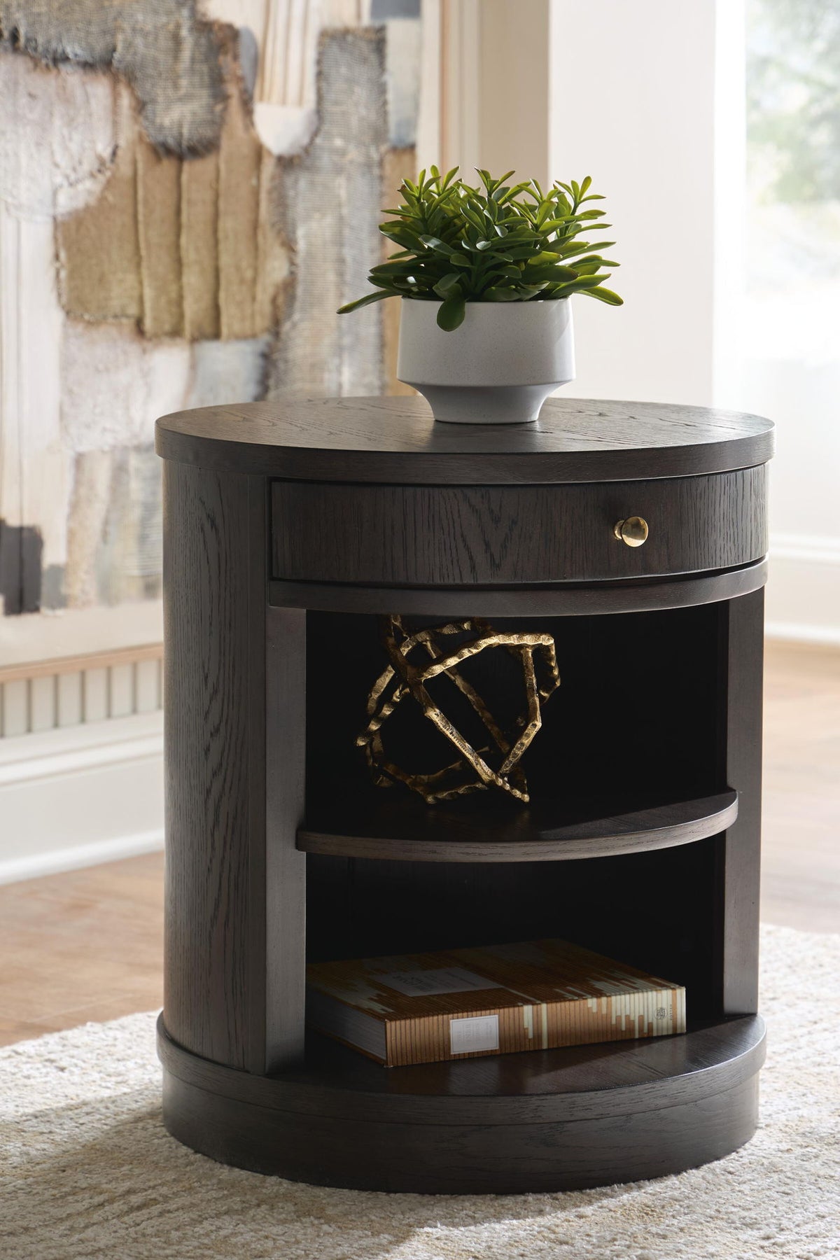 Dark brown round accent table with drawer and open cubby shelves