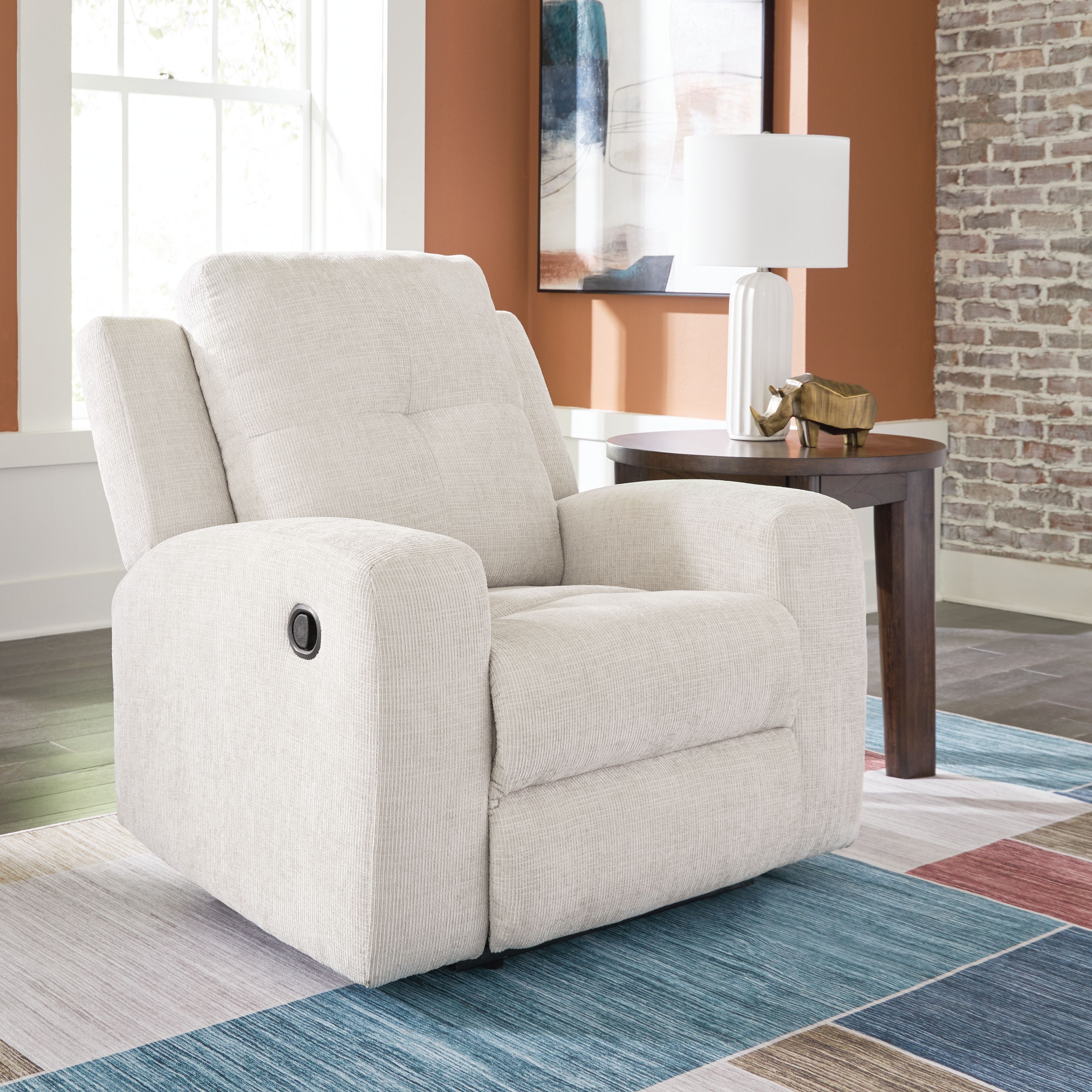 Stone fabric wall recliner with tall back, padded arms, and oval button on side