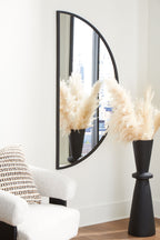 Tall arched accent mirror with black frame and reflective glass panel.