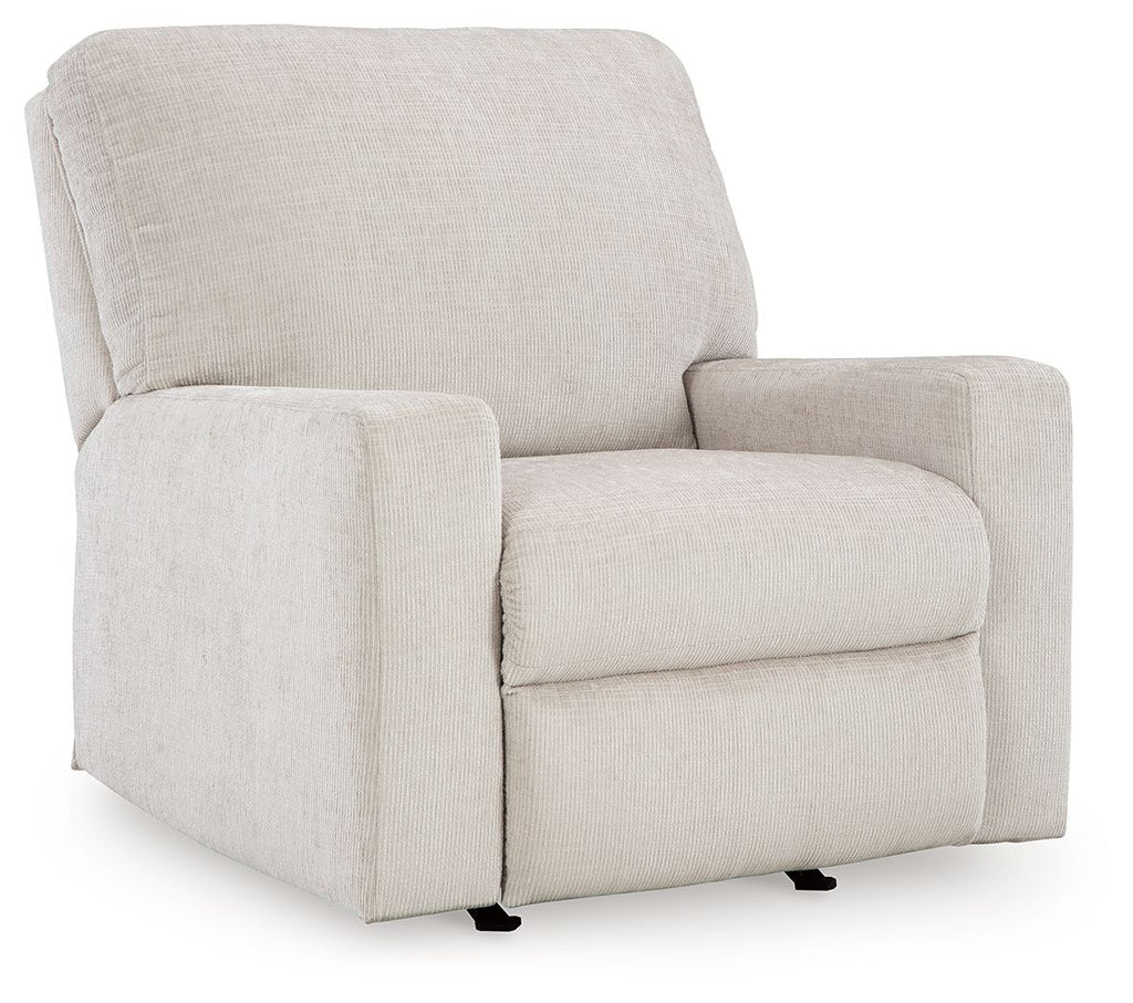 Rocker recliner chair in light beige upholstered fabric with thick back cushion.