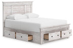 Panel storage bed with white mattress, light gray wood frame, open front storage compartments