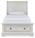 White sleigh bed with two storage drawers in the footboard and paneled headboard.