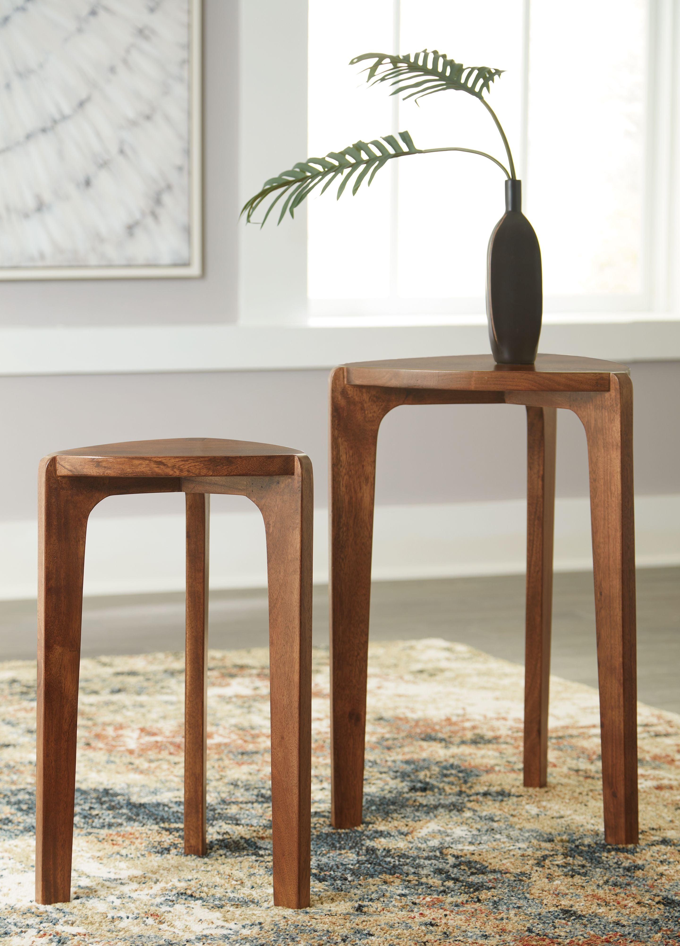 Two wooden accent tables, medium brown, round tops and tapered legs