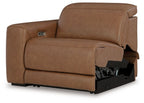 Caramel brown power recliner with padded armrests and footrest, side view