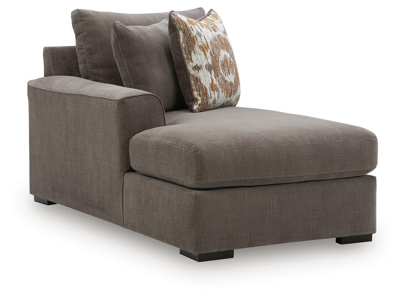 Dark brown chaise corner piece with padded chaise seat and patterned back throw pillow