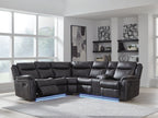 Dark carbon reclining sectional sofa with tufted back cushions and an extended chaise section.