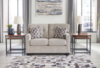 Light beige loveseat with two matching patterned cushions on the seats