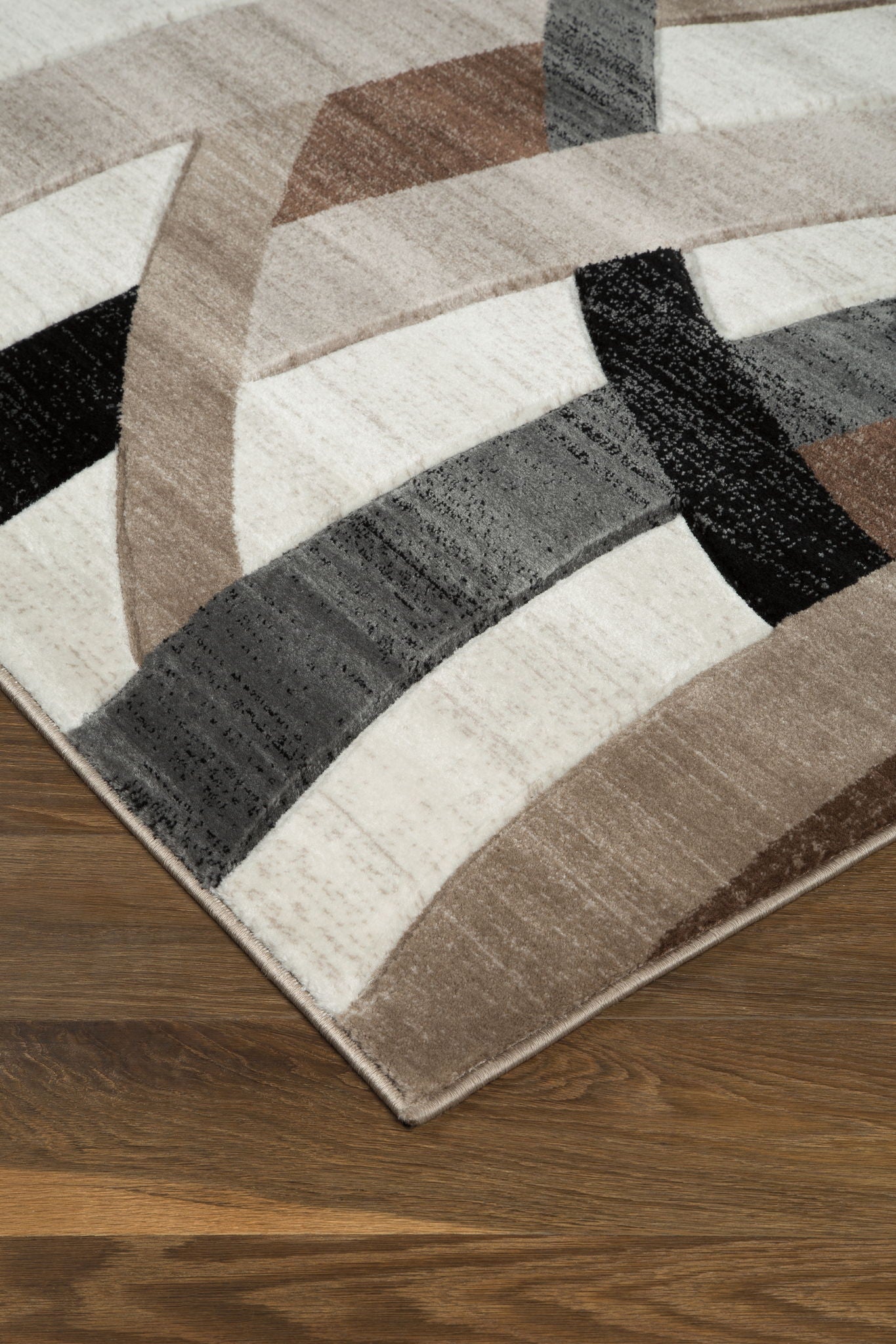 Jacinth rug with geometric stripes in dark brown, tan, gray, and black