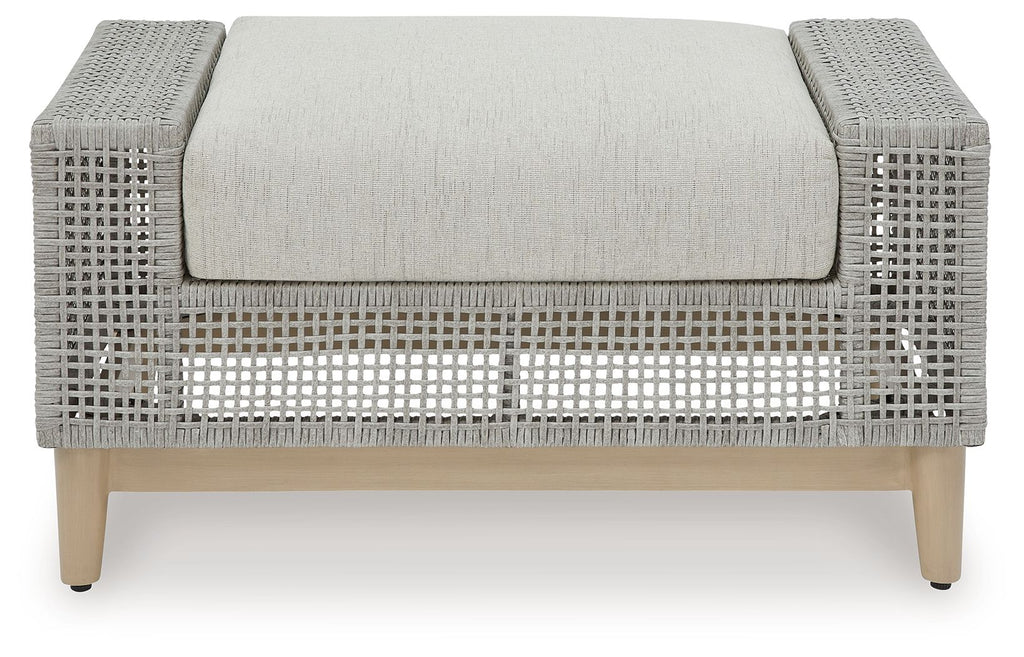 Gray ottoman with rounded armrests, woven texture, and centered upholstered cushion