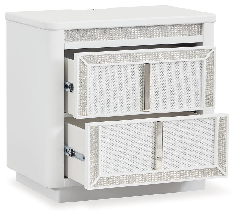 White two-drawer nightstand with one drawer pulled out, side-mounted metal slides.