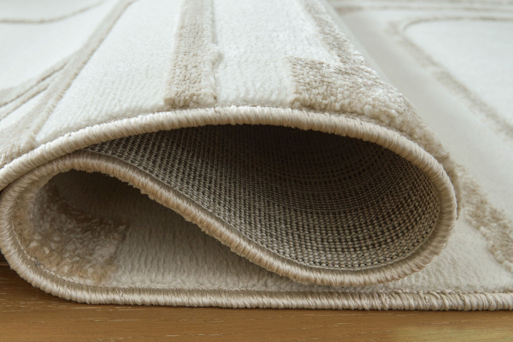 Beige rug with curled low-pile edge and textured weave, bordered