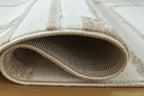 Beige rug with curled low-pile edge and textured weave, bordered