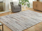 Nace area rug, cream and gray distressed lines, laid flat in living room