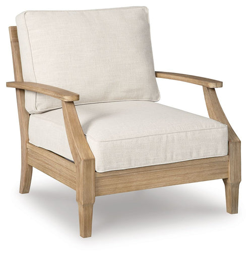 Beige lounge chair with cushion, light wood arms and frame, upholstered backrest.