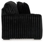 Ribbed dark sectional sofa back and seat with deep channel stitching and rounded arms