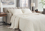 Pebble sofa sleeper with an extended bed and layered white bedding