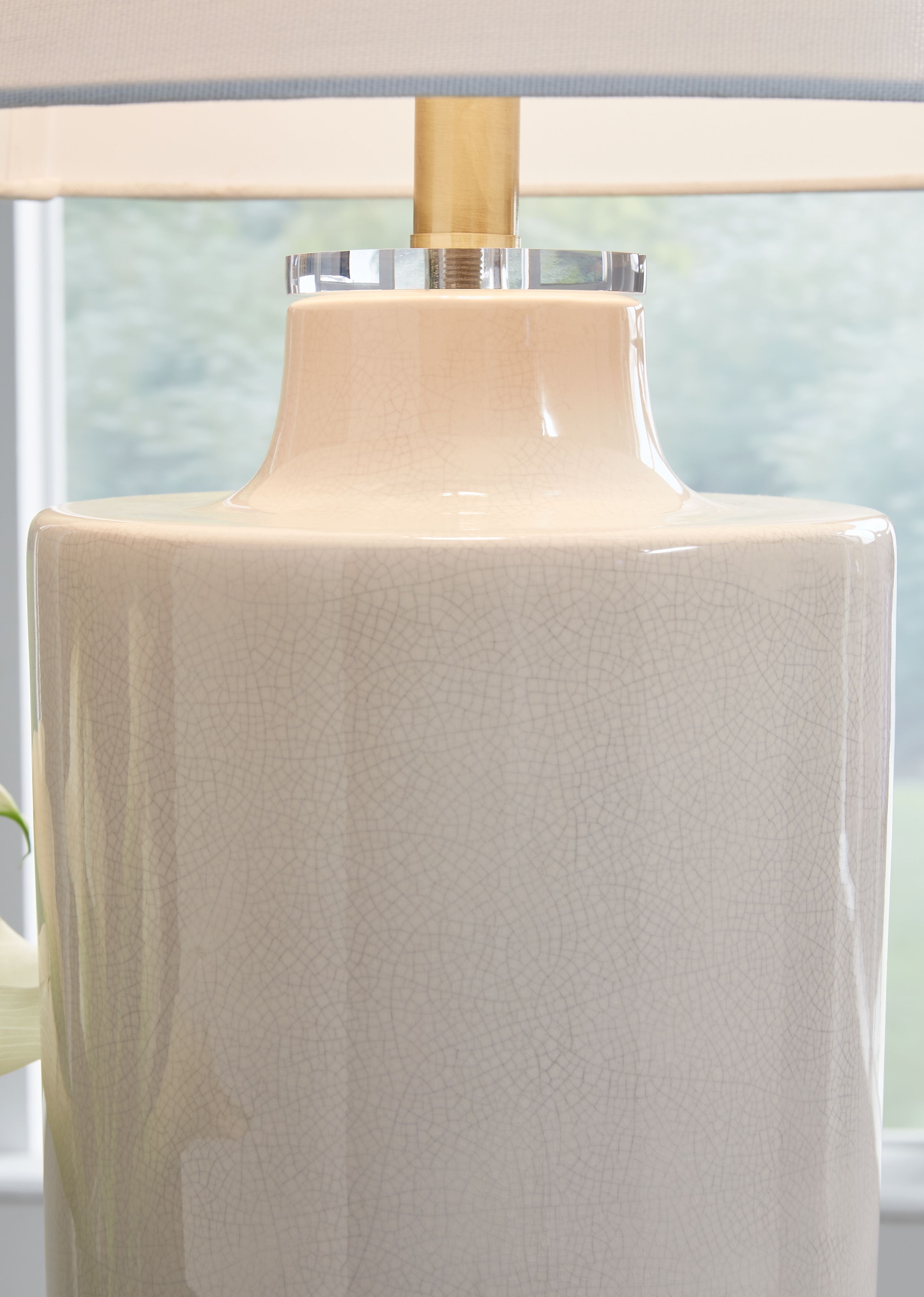 Off-white ceramic lamp base with glossy top and drum fabric shade