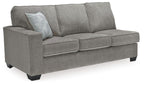 Gray fabric sofa sleeper with rounded arms and three back cushions