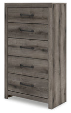 Five-drawer chest in gray wood with metal bar pulls, angled side view.
