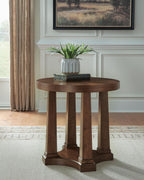 Round light brown wood end table with pedestal base in living room setting