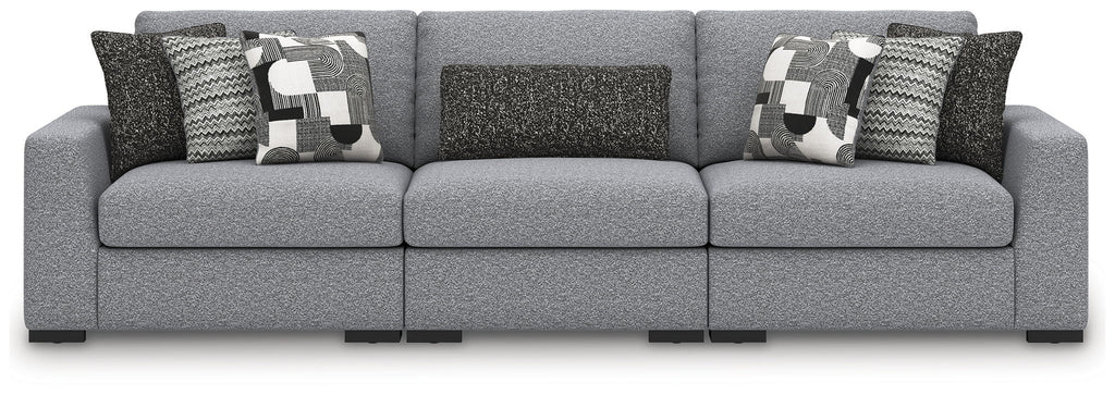 Gray sectional sofa with three-seat center and patterned throw pillows