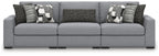 Gray sectional sofa with three-seat center and patterned throw pillows