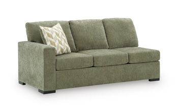 Moss green upholstered sofa with square arms, tufted cushions, and a light throw pillow