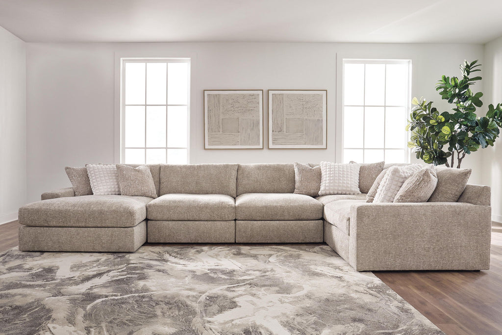 Tan burlap sectional sofa with double chaise layout and multiple back cushions