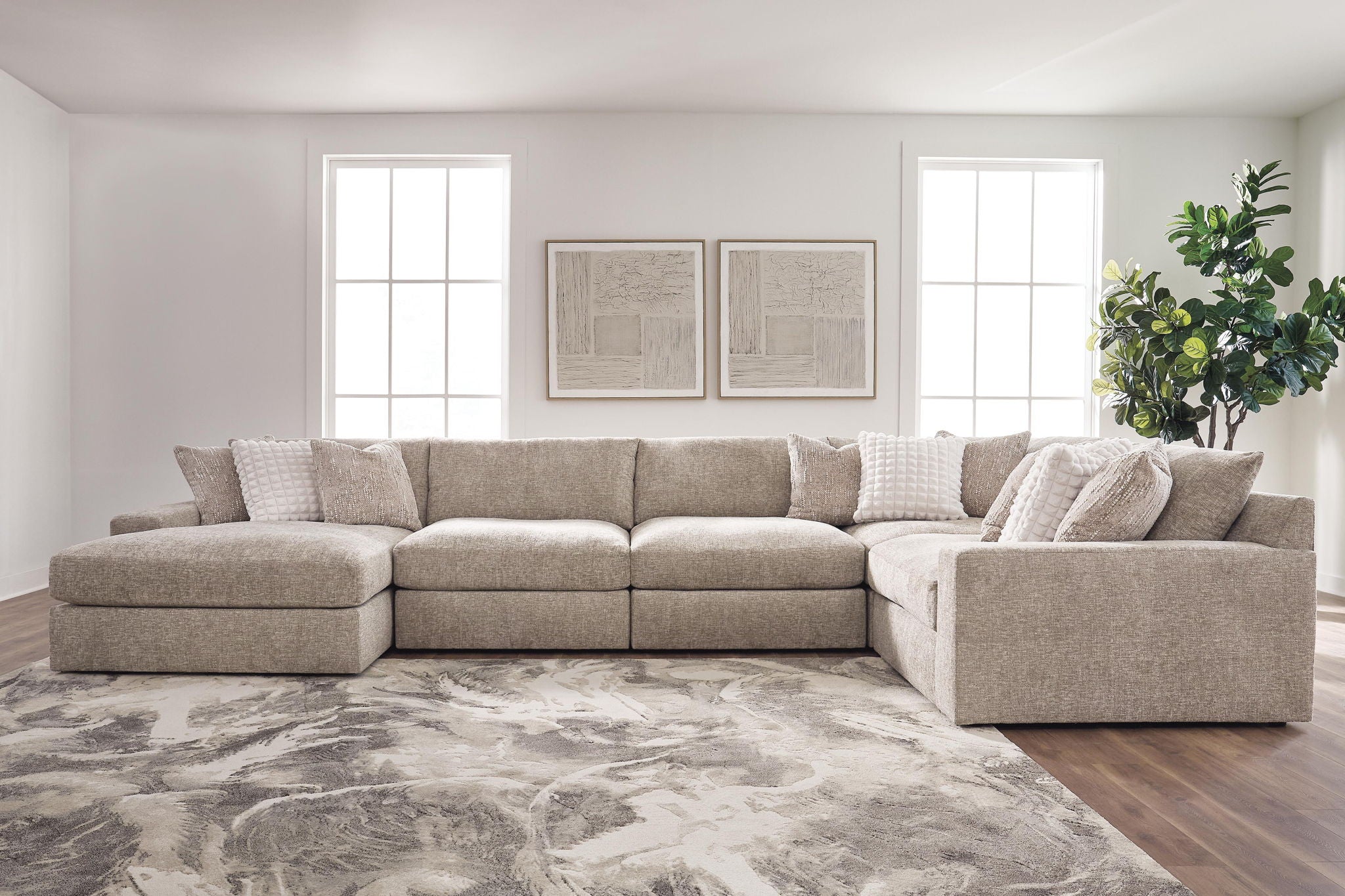 Tan burlap sectional sofa with double chaise layout and multiple back cushions