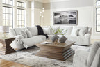 Light gray reclining sectional sofa with chaise and patterned accent pillows