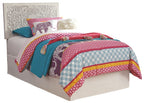 Twin bed with whitewash panel headboard and multicolor patterned quilt set